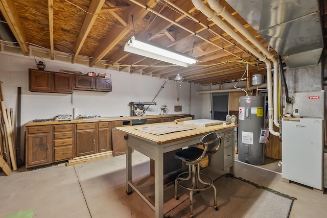 unfinished below grade area with heating unit, a workshop area, and electric water heater