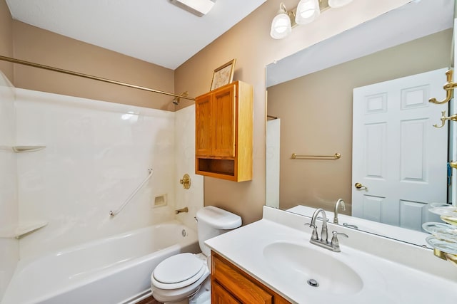 bathroom with vanity, toilet, and  shower combination