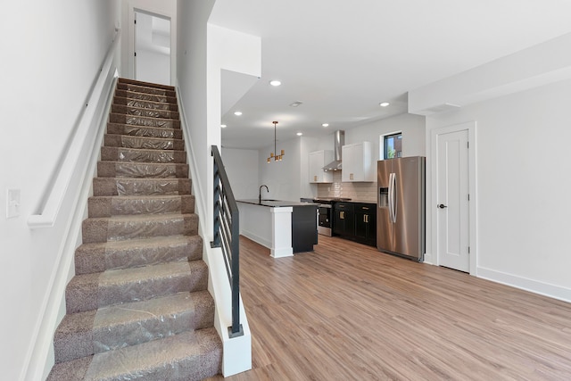 stairs featuring baseboards, recessed lighting, and wood finished floors