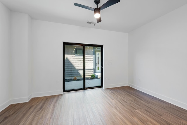 unfurnished room with baseboards, ceiling fan, visible vents, and wood finished floors