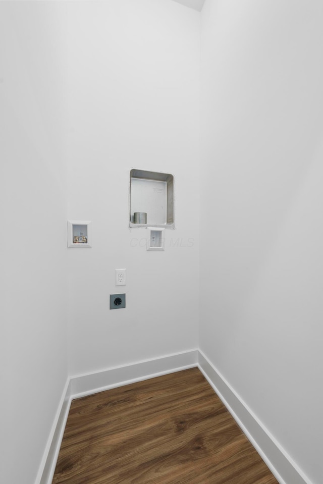 clothes washing area with dark wood-style flooring, washer hookup, laundry area, baseboards, and electric dryer hookup