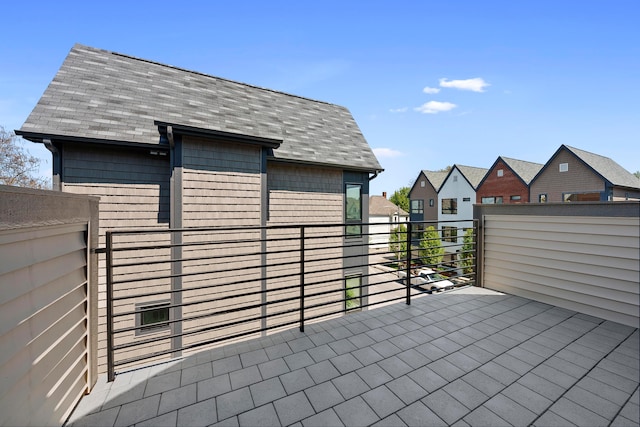 view of patio featuring a balcony and a residential view