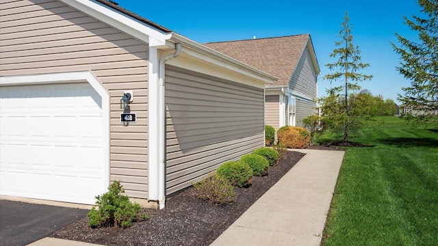 42 Ellington Commons Ln, Granville, OH 43023 - view of home's exterior with a lawn, a shingled roof, and a garage