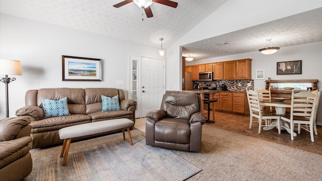 42 Ellington Commons Ln, Granville, OH 43023 - living area featuring ceiling fan, a textured ceiling, light colored carpet, light tile patterned floors, and lofted ceiling