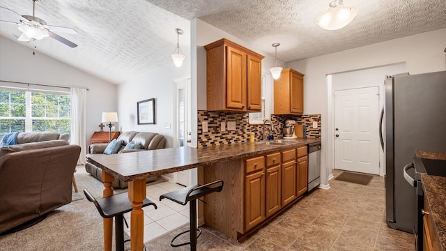 42 Ellington Commons Ln, Granville, OH 43023 - kitchen featuring a textured ceiling, open floor plan, dark countertops, and dishwasher