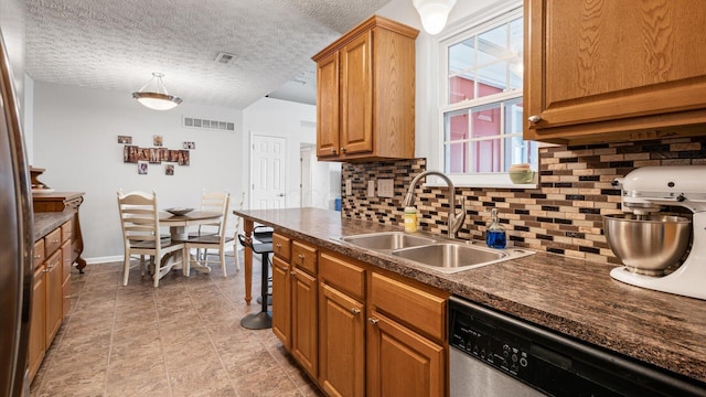 42 Ellington Commons Ln, Granville, OH 43023 - kitchen featuring a sink, dark countertops, stainless steel dishwasher, and visible vents