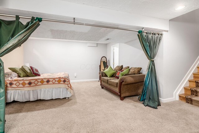 carpeted bedroom featuring baseboards and a textured ceiling