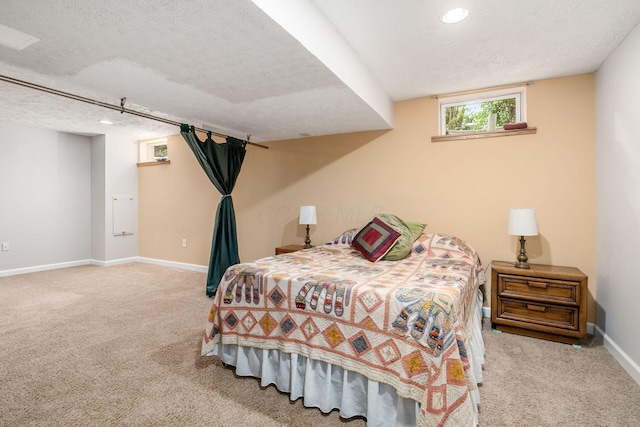 carpeted bedroom featuring baseboards, recessed lighting, and a textured ceiling