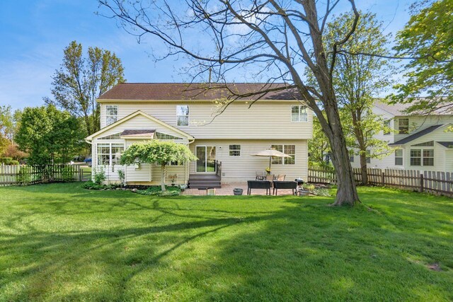 back of house with a lawn, a patio, a fenced backyard, and entry steps