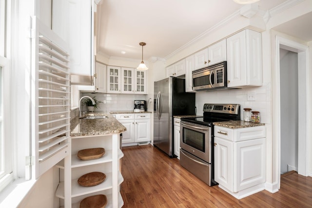 439 Chatham Rd, Columbus, OH 43214 - kitchen with glass insert cabinets, a sink, stainless steel appliances, white cabinetry, and decorative backsplash