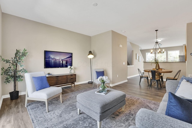 483 Autumn Ridge Cir, Pickerington, OH 43147 - living room with a chandelier, wood finished floors, and baseboards