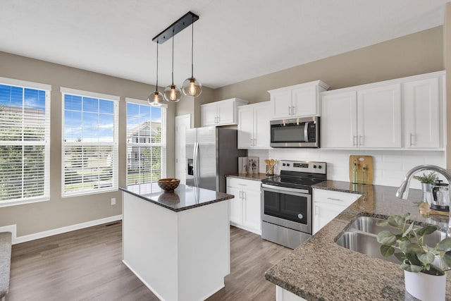 483 Autumn Ridge Cir, Pickerington, OH 43147 - kitchen featuring appliances with stainless steel finishes, a sink, backsplash, baseboards, and wood finished floors
