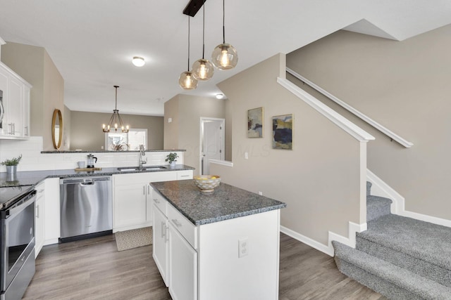 483 Autumn Ridge Cir, Pickerington, OH 43147 - kitchen with appliances with stainless steel finishes, a peninsula, wood finished floors, and tasteful backsplash