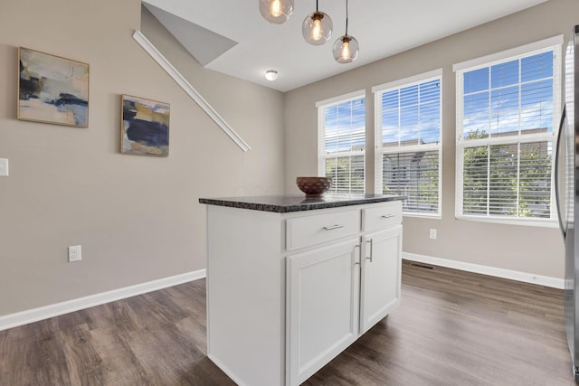 483 Autumn Ridge Cir, Pickerington, OH 43147 - kitchen with dark wood finished floors, baseboards, dark countertops, decorative light fixtures, and white cabinets