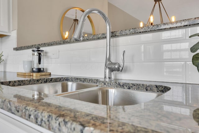 483 Autumn Ridge Cir, Pickerington, OH 43147 - detailed view of a sink, backsplash, stone countertops, and white cabinets