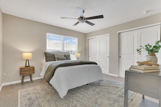 483 Autumn Ridge Cir, Pickerington, OH 43147 - bedroom featuring multiple closets, baseboards, light colored carpet, and a ceiling fan