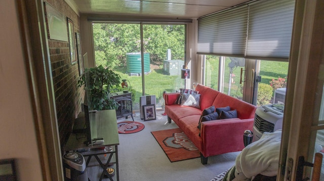 sunroom / solarium featuring a healthy amount of sunlight and carpet floors
