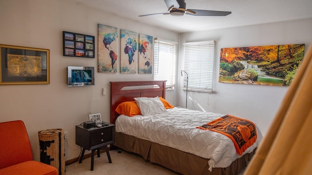 bedroom with a ceiling fan and carpet