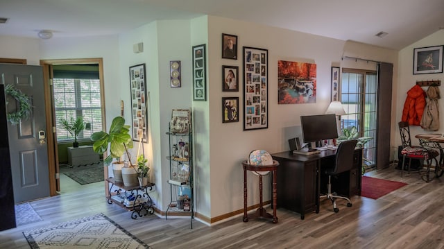 home office with baseboards, visible vents, and wood finished floors