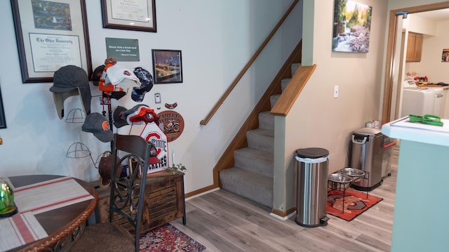 stairway with washer / dryer and wood finished floors