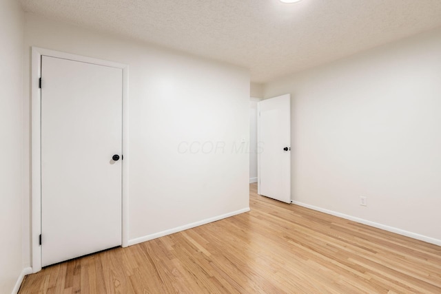 2583 Kingston Ave, Grove City, OH 43123 - unfurnished bedroom featuring a textured ceiling, baseboards, and light wood-type flooring
