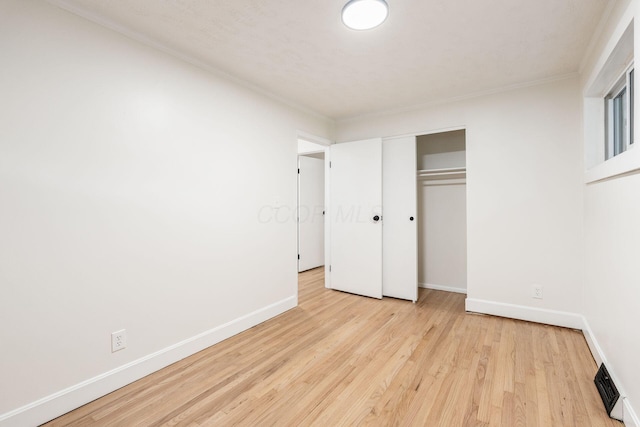 2583 Kingston Ave, Grove City, OH 43123 - unfurnished bedroom featuring light wood-style flooring, baseboards, visible vents, ornamental molding, and a closet