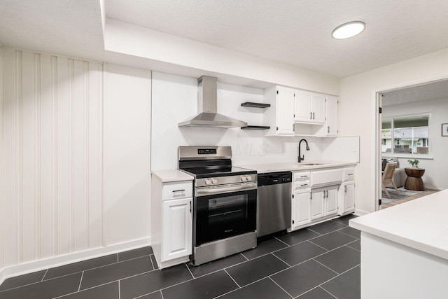 2583 Kingston Ave, Grove City, OH 43123 - kitchen featuring a sink, light countertops, white cabinets, stainless steel appliances, and wall chimney exhaust hood
