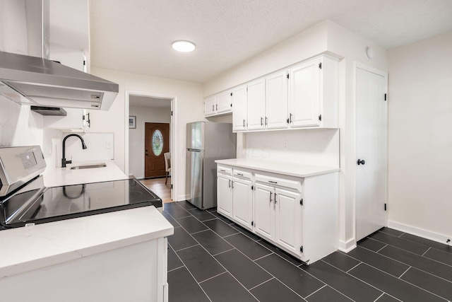 2583 Kingston Ave, Grove City, OH 43123 - kitchen with freestanding refrigerator, extractor fan, light countertops, white cabinets, and a sink