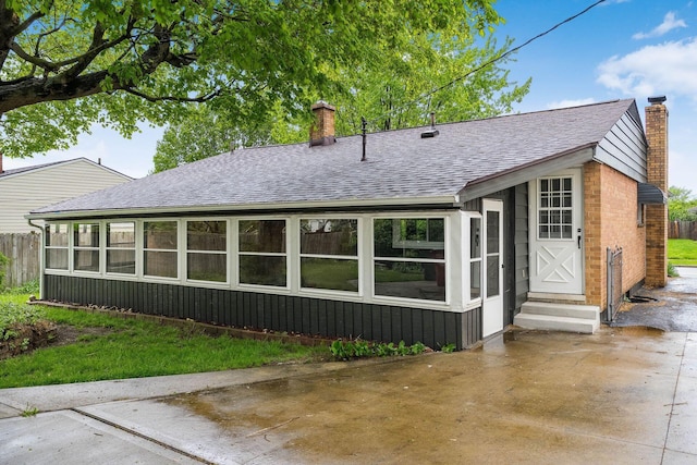 2583 Kingston Ave, Grove City, OH 43123 - back of property featuring roof with shingles, fence, a chimney, and entry steps