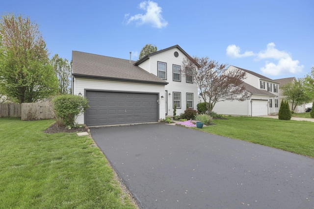 347 Wyncroft Ct, Pataskala, OH 43062 - traditional home featuring a garage, fence, a front yard, and aphalt driveway