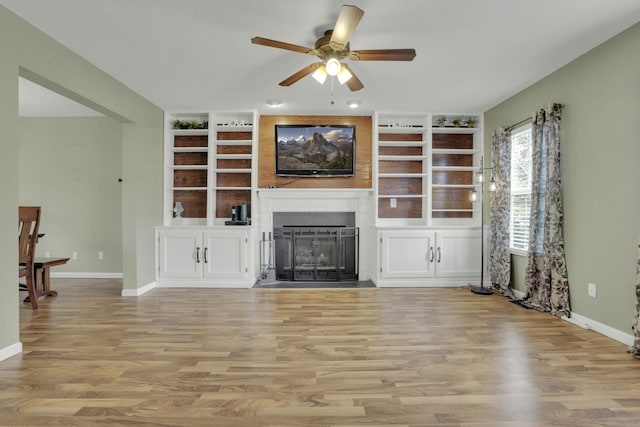 347 Wyncroft Ct, Pataskala, OH 43062 - unfurnished living room with ceiling fan, built in shelves, baseboards, and a fireplace