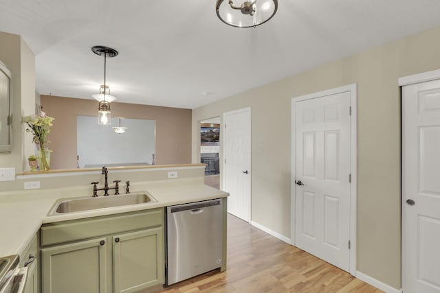 347 Wyncroft Ct, Pataskala, OH 43062 - kitchen with a sink, dishwasher, light wood-style flooring, a peninsula, and decorative light fixtures