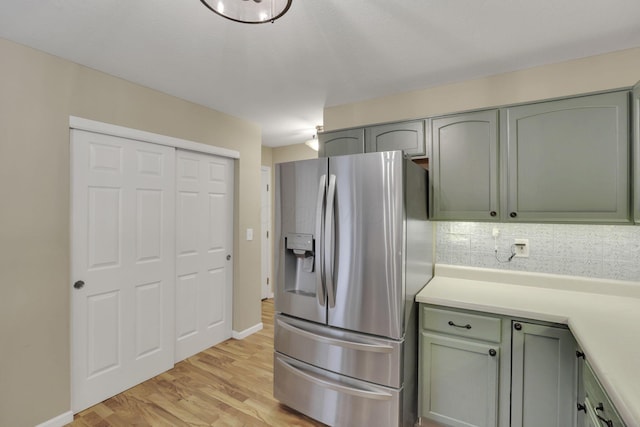 347 Wyncroft Ct, Pataskala, OH 43062 - kitchen with light countertops, green cabinetry, light wood finished floors, and stainless steel fridge with ice dispenser