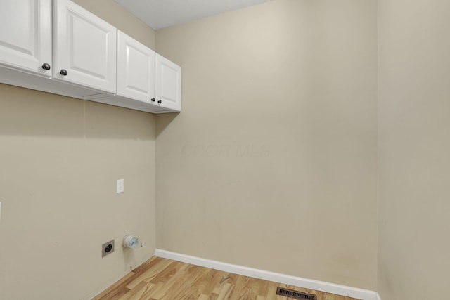 347 Wyncroft Ct, Pataskala, OH 43062 - washroom with hookup for an electric dryer, visible vents, cabinet space, baseboards, and light wood-style floors