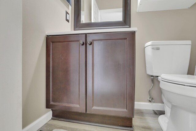 347 Wyncroft Ct, Pataskala, OH 43062 - half bathroom with baseboards, wood finished floors, toilet, and vanity