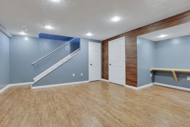 347 Wyncroft Ct, Pataskala, OH 43062 - finished below grade area featuring stairs, wood finished floors, baseboards, recessed lighting, and a textured ceiling