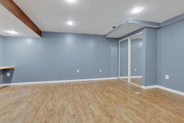 347 Wyncroft Ct, Pataskala, OH 43062 - finished below grade area with a textured ceiling, baseboards, and light wood-type flooring