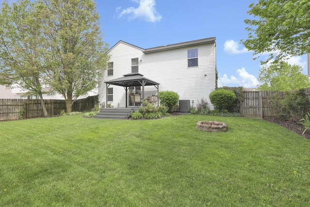347 Wyncroft Ct, Pataskala, OH 43062 - back of house featuring a gazebo, a fenced backyard, a fire pit, and cooling unit