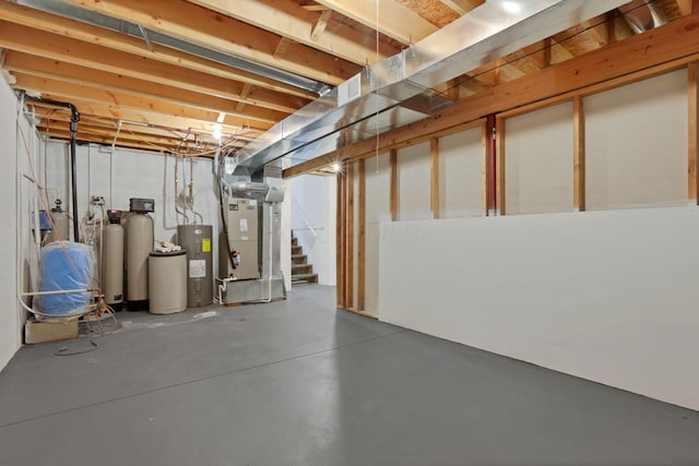 1889 Wolverine Dr, Sugar Grove, OH 43155 - unfinished below grade area featuring heating unit, a water softener system, electric water heater, and stairs