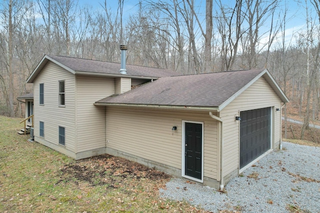 1889 Wolverine Dr, Sugar Grove, OH 43155 - view of property exterior with roof with shingles and a detached garage