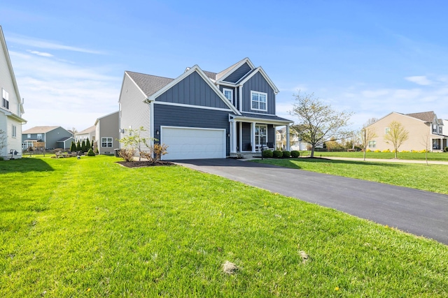 traditional-style house with a garage, board and batten siding, driveway, and a front lawn