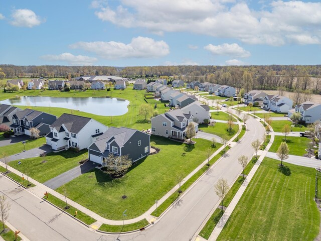 drone / aerial view featuring a water view and a residential view