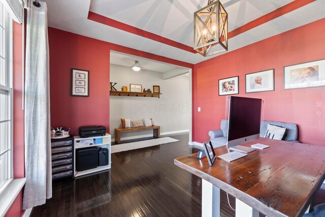 office featuring baseboards, an inviting chandelier, and hardwood / wood-style flooring