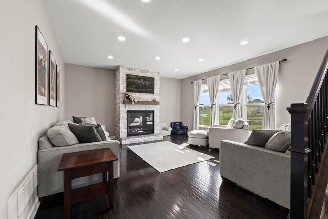living room featuring visible vents, recessed lighting, dark wood-style flooring, and a fireplace