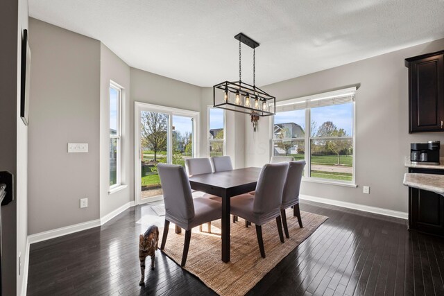 dining space with baseboards and dark wood-type flooring
