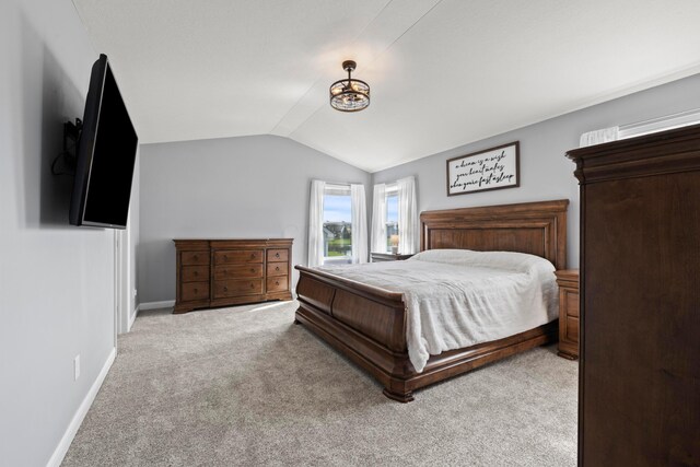 bedroom featuring baseboards, carpet, and lofted ceiling