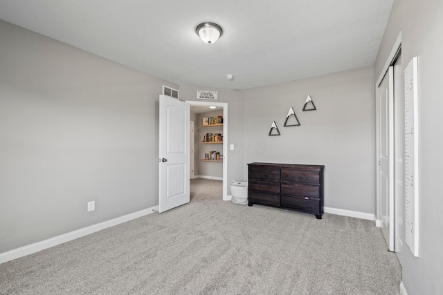 bedroom with baseboards, carpet flooring, and visible vents