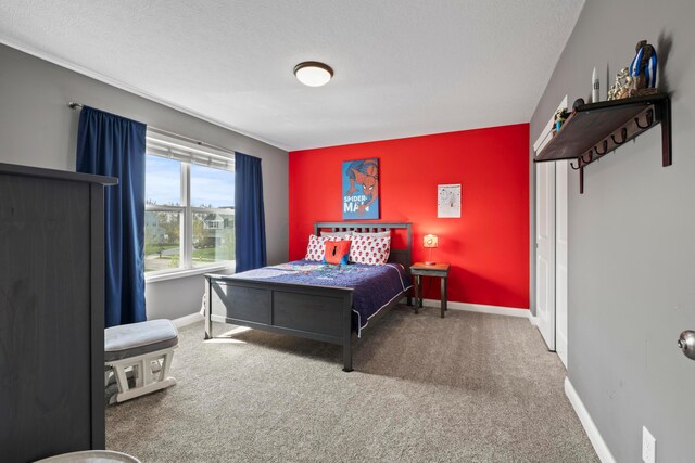 carpeted bedroom with baseboards and a textured ceiling