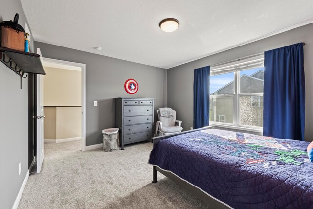 bedroom featuring carpet floors and baseboards