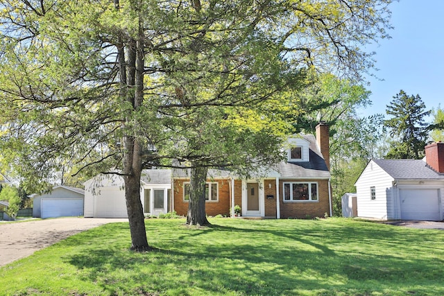view of front of house with brick siding, a chimney, an outbuilding, and a front yard